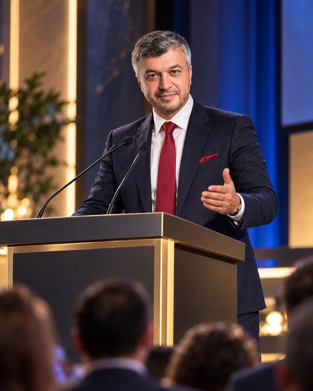 Bob Khodjaev speaking at a podium